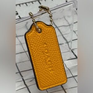 Coach Yellow & black edge Textured stamped leather hang tag Keychain. 2 X 1 inch